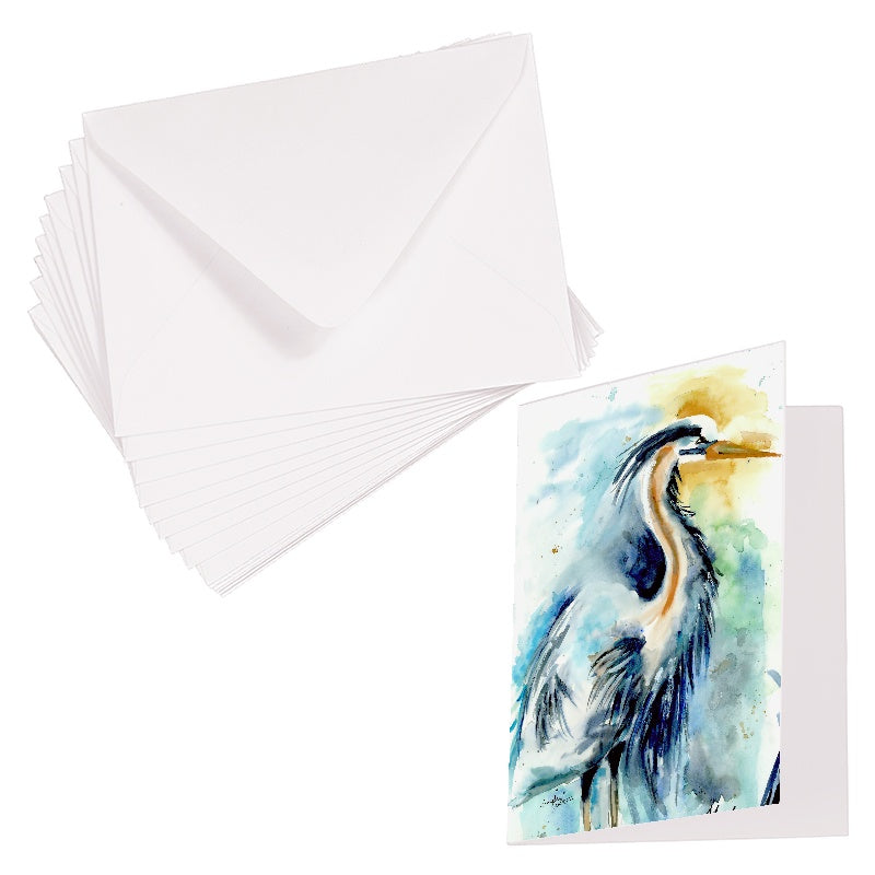 Folding cardstock greeting card featuring original watercolor piece Male Heron laying next to a stack of euro flap envelopes.
