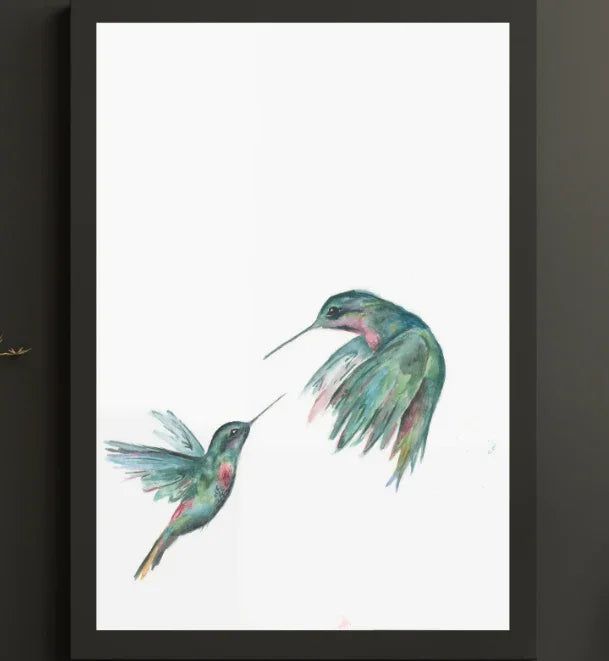 Watercolor painting of two colorful hummingbirds facing each other on white background