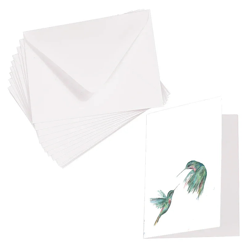 White greeting card and envelopes set featuring watercolor dueling hummingbirds design