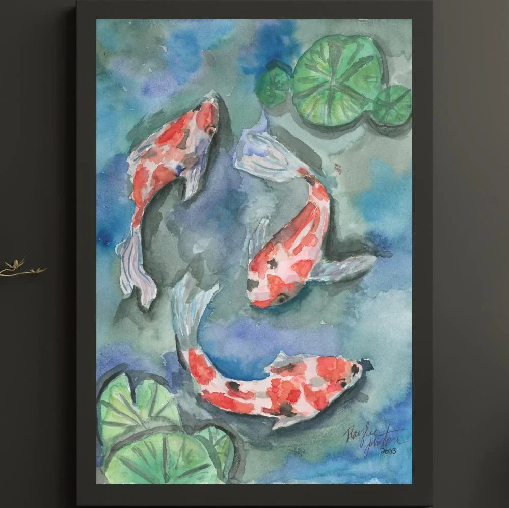 Watercolor painting of three red and white koi fish swimming among green lily pads