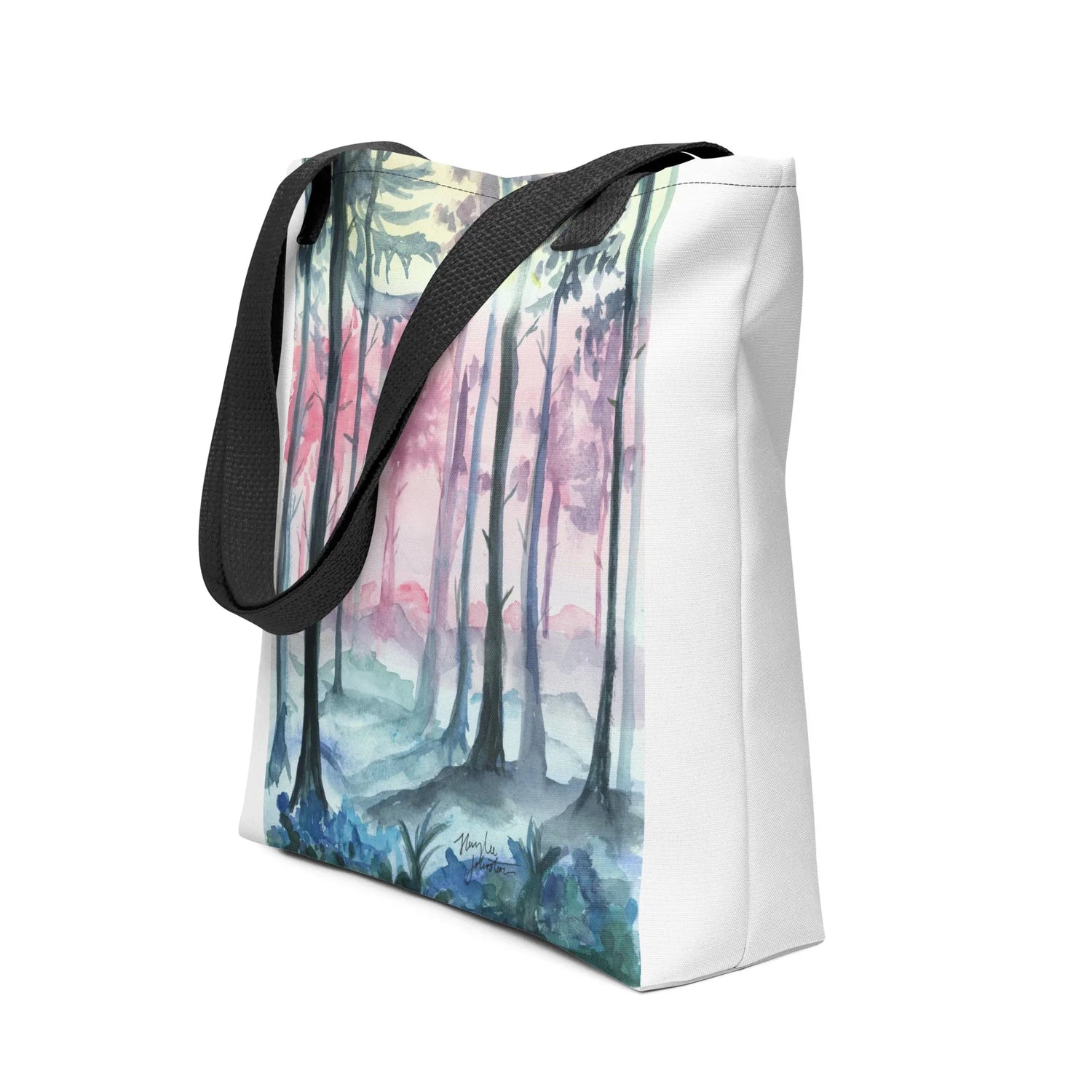 White tote bag with black handles featuring watercolor forest print in blue, pink, and green tones