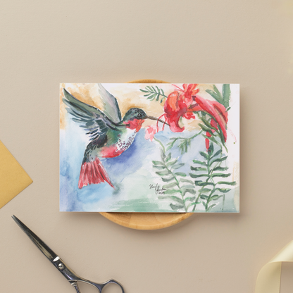 Flat cardstock note card featuring original watercolor piece A Garden Visit Resting on a small wooden plate next to silver scissors.