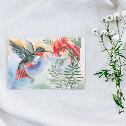 Flat cardstock note card featuring original watercolor piece A Garden Visit on a white linen background next to fresh white flowers.