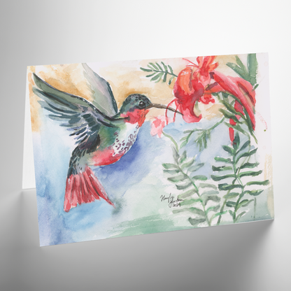 Folding cardstock greeting card featuring original watercolor piece A Garden Visit resting open and backlit on a white table.
