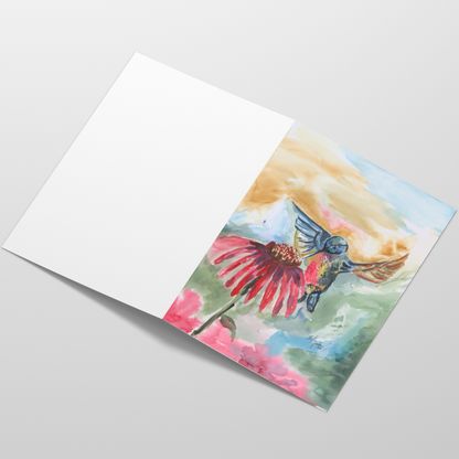 Folding cardstock greeting card featuring original watercolor piece A Jeweled Messenger laying open in a table with the outside facing up.