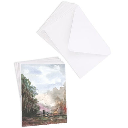 A stack of flat cardstock note cards featuring original watercolor piece A Walk in the Forest next to a stack of the matching euro flap envelopes.