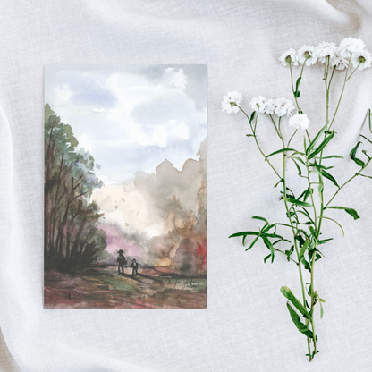 Flat cardstock note card featuring original watercolor piece A Walk in the Forest on a white linen background next to fresh white flowers.