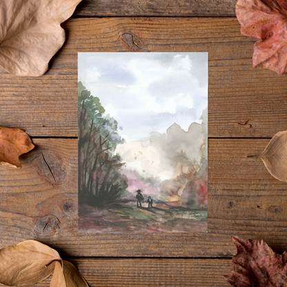 Flat cardstock note card featuring original watercolor piece A Walk in the Forest styled on rustic wooden boards with dried autumn leaves.
