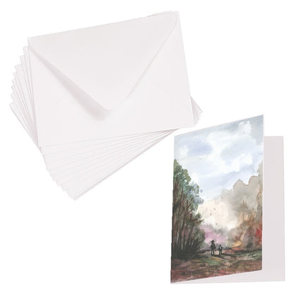 Folding cardstock greeting card featuring original watercolor piece A Walk in the Forest laying next to a stack of euro flap envelopes.