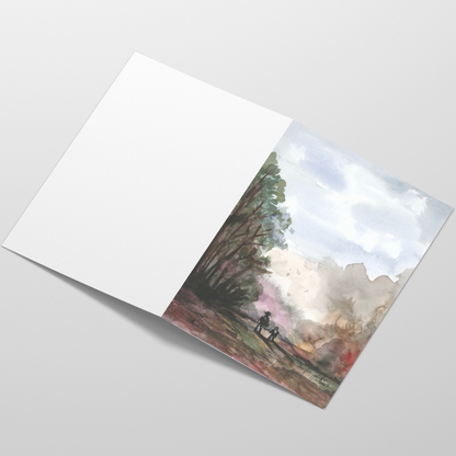 Folding cardstock greeting card featuring original watercolor piece A Walk in the Forest laying open in a table with the outside facing up.