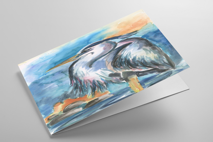 Folding greeting card featuring original watercolor piece Dark Heron laying down showing cardstock thickness and blank inside.