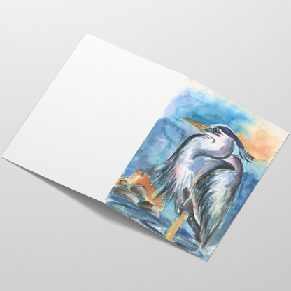 Folding cardstock greeting card featuring original watercolor piece Dark Heron laying open in a table with the outside facing up.