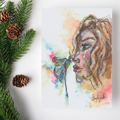 Flat cardstock note card featuring original watercolor piece Dragonfly Girl on a white background. Green pine fronds with brown pinecones decorate the left side.