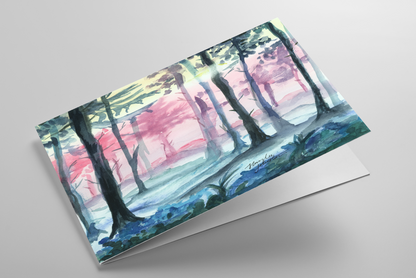 Folding greeting card featuring original watercolor piece Fairy Forest laying down showing cardstock thickness and blank inside.