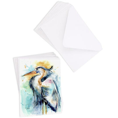 A stack of flat cardstock note cards featuring original watercolor piece Female Heron next to a stack of the matching euro flap envelopes.