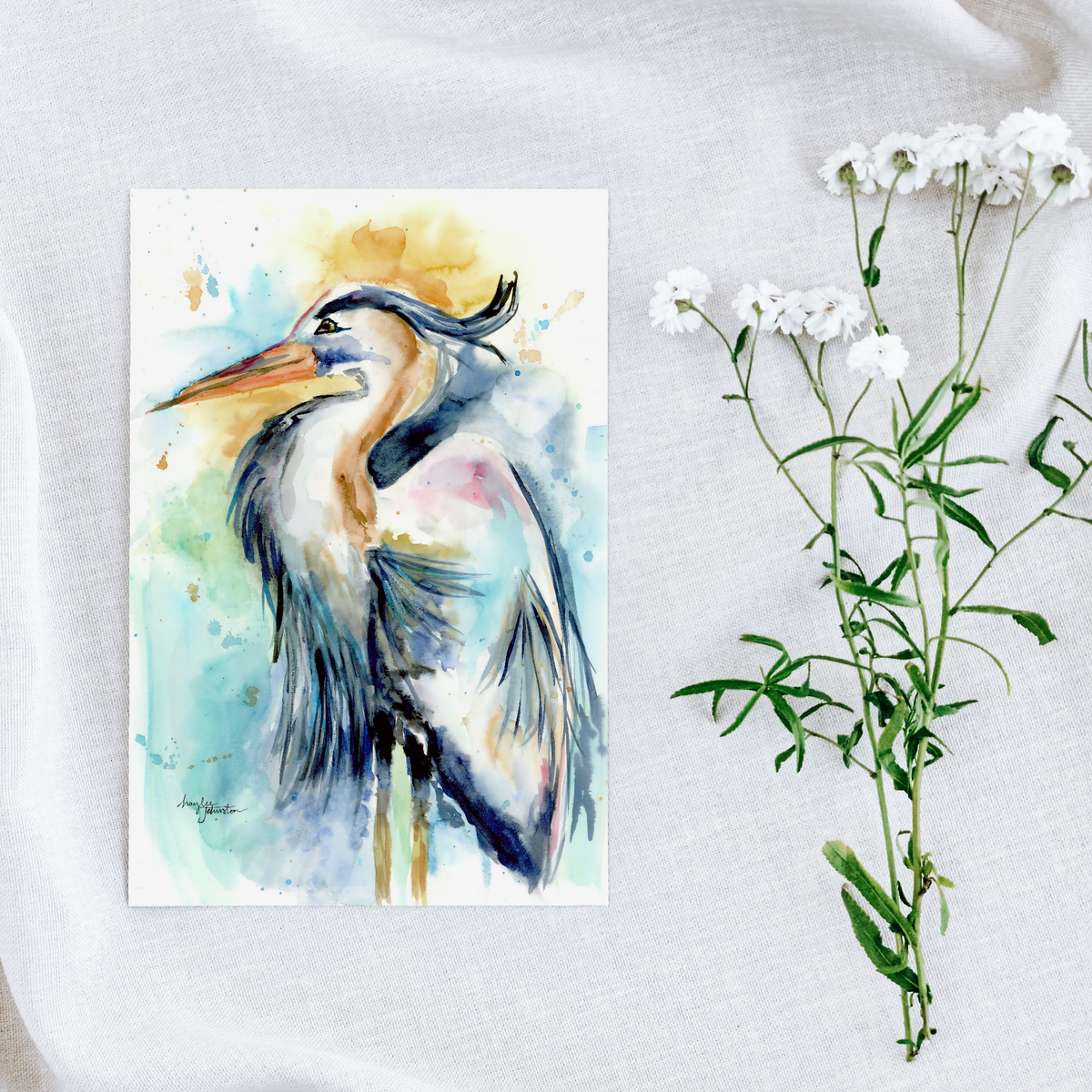 Flat cardstock note card featuring original watercolor piece Female Heron on a white linen background next to fresh white flowers.