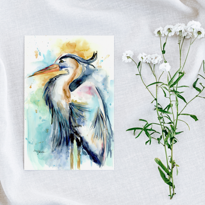 Flat cardstock note card featuring original watercolor piece Female Heron on a white linen background next to fresh white flowers.