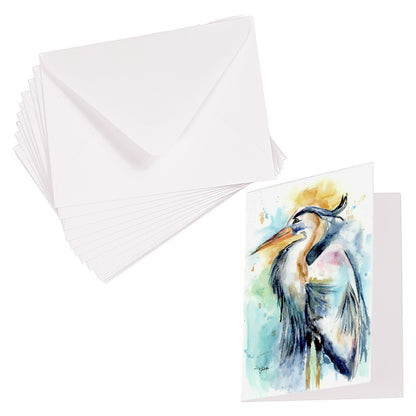 Folding cardstock greeting card featuring original watercolor piece Female Heron laying next to a stack of euro flap envelopes.