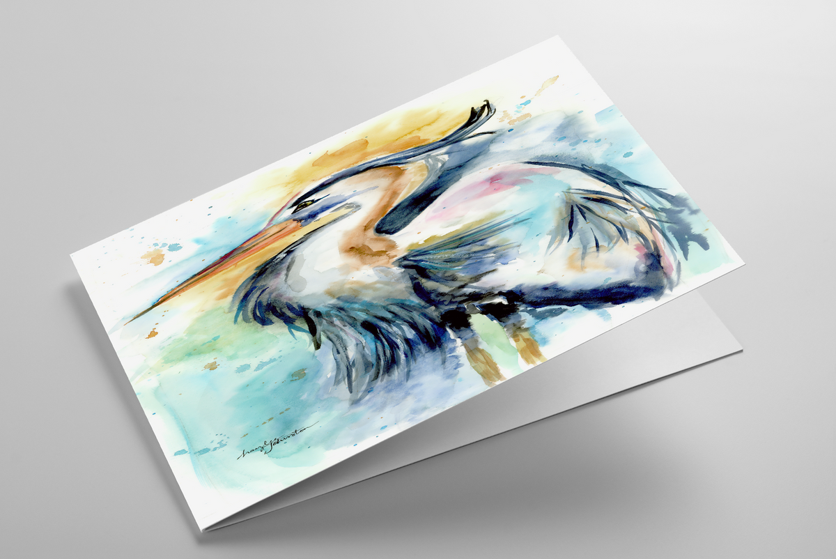 Folding greeting card featuring original watercolor piece Female Heron laying down showing cardstock thickness and blank inside.
