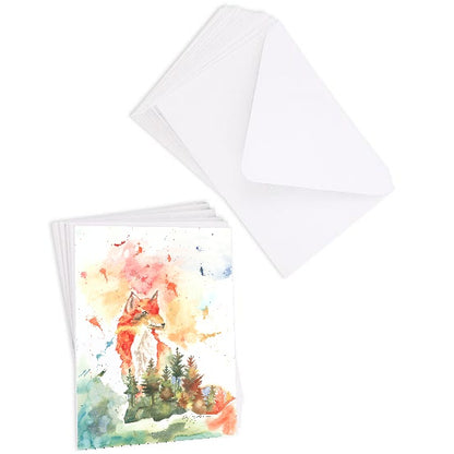 A stack of flat cardstock note cards featuring original watercolor piece Forest Fox next to a stack of the matching euro flap envelopes.