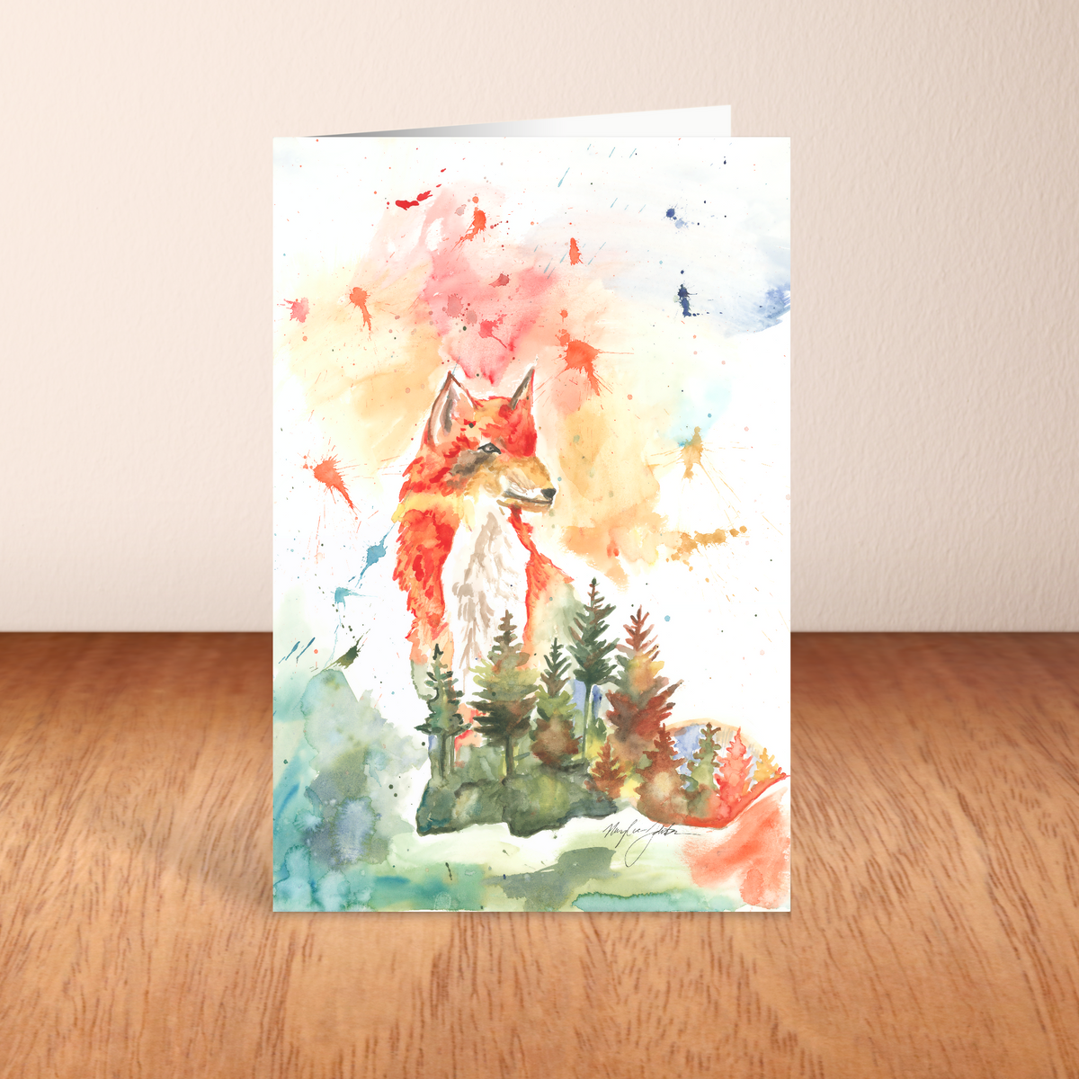 Folding cardstock greeting card featuring original watercolor piece Forest Fox standing upright on a wooden table.