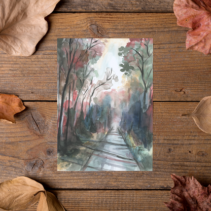 Flat cardstock note card featuring original watercolor piece Forest Road styled on rustic wooden boards with dried autumn leaves.