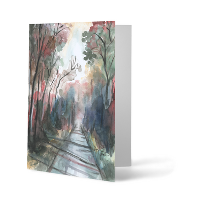 Folding cardstock greeting card featuring original watercolor piece Forest Road standing upright.