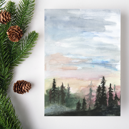 Flat cardstock note card featuring original watercolor piece Forest Skyline on a white background. Green pine fronds with brown pinecones decorate the left side.