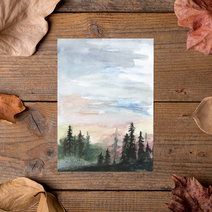 Flat cardstock note card featuring original watercolor piece Forest Skyline styled on rustic wooden boards with dried autumn leaves.