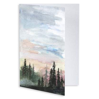 Folding cardstock greeting card featuring original watercolor piece Forest Skyline slightly open to display the empty inside.