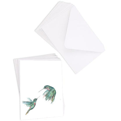 A stack of flat cardstock note cards featuring original watercolor piece Hummingbird Duel next to a stack of the matching euro flap envelopes.