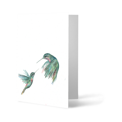 Folding cardstock greeting card featuring original watercolor piece Hummingbird Duel standing upright.