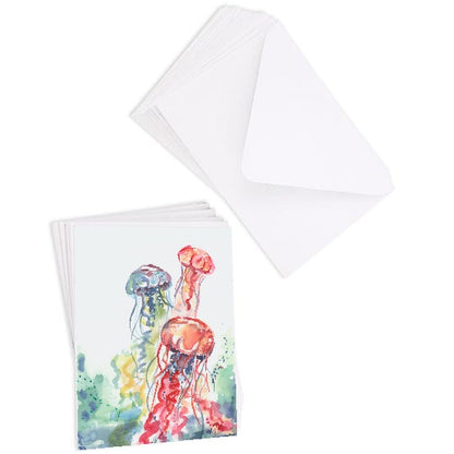 A stack of flat cardstock note cards featuring original watercolor piece Jellyfish Bloom next to a stack of the matching euro flap envelopes.