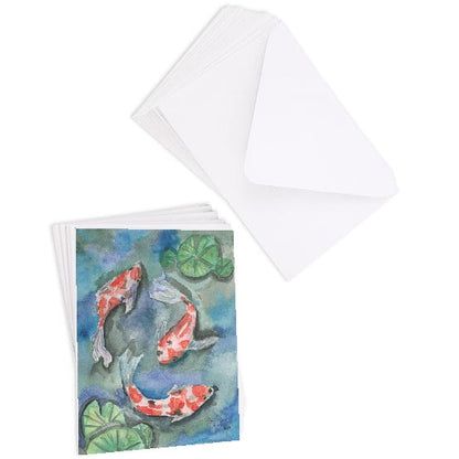 A stack of flat cardstock note cards featuring original watercolor piece Koi Pond next to a stack of the matching euro flap envelopes.