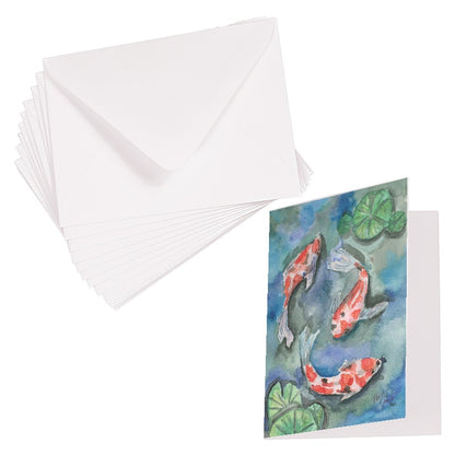 Folding cardstock greeting card featuring original watercolor piece Koi Pond laying next to a stack of euro flap envelopes.