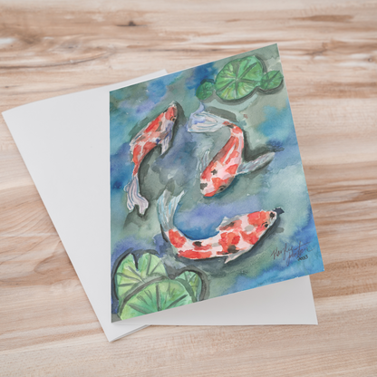 Folding cardstock greeting card featuring original watercolor piece Koi Pond laying one on top of another.
