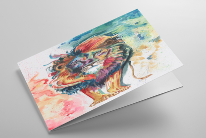 Folding greeting card featuring original watercolor piece Lion of Judah laying down showing cardstock thickness and blank inside.