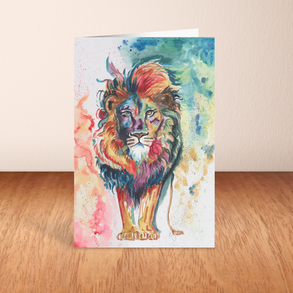 Folding cardstock greeting card featuring original watercolor piece Lion of Judah standing upright on a wooden table.