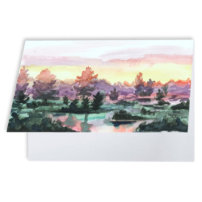 Folding cardstock greeting card featuring original watercolor piece Misty Sunrise slightly open to display the empty inside.