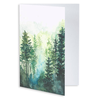 Folding cardstock greeting card featuring original watercolor piece Morning Forest slightly open to display the empty inside.