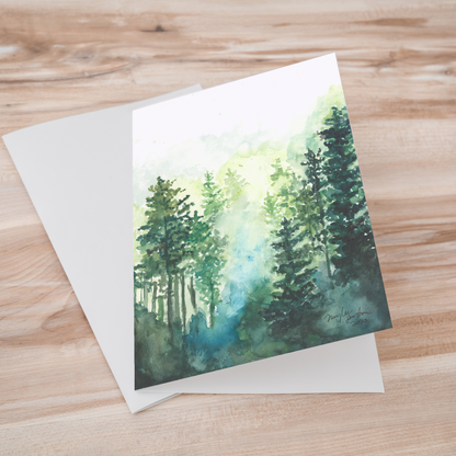 Folding cardstock greeting card featuring original watercolor piece Morning Forest laying one on top of another.