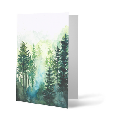 Folding cardstock greeting card featuring original watercolor piece Morning Forest standing upright.