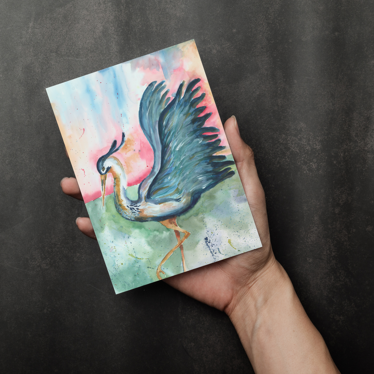 Flat cardstock note card featuring original watercolor piece Morning Glories in a person's right hand. The background transitions from black at the bottom to a dull gray at the top.