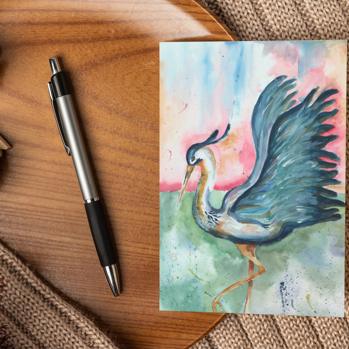 Flat cardstock note card featuring original watercolor piece Morning Glories displayed on a wooden surface beside a black and silver pen.