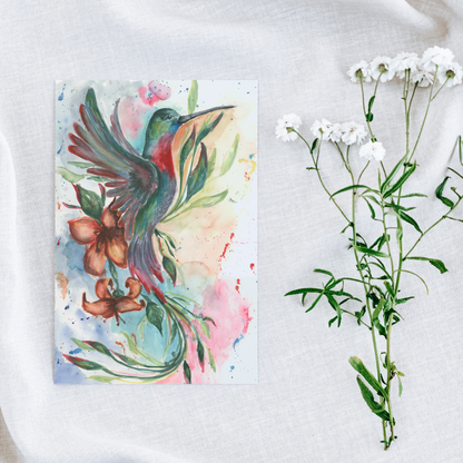Flat cardstock note card featuring original watercolor piece Queen of Flight on a white linen background next to fresh white flowers.