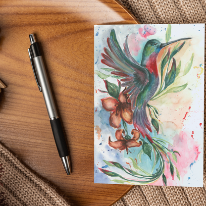 Flat cardstock note card featuring original watercolor piece Queen of Flight displayed on a wooden surface beside a black and silver pen.