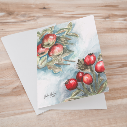 Folding cardstock greeting card featuring original watercolor piece Red Apples and Rosehips laying one on top of another.