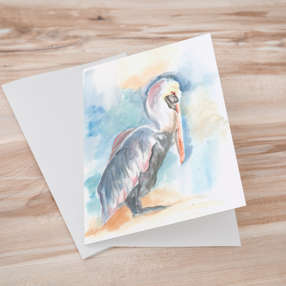 Folding cardstock greeting card featuring original watercolor piece Shy Pelican laying one on top of another.
