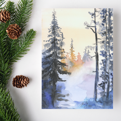 Flat cardstock note card featuring original watercolor piece Winter Wood on a white background. Green pine fronds with brown pinecones decorate the left side.