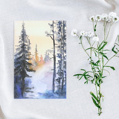 Flat cardstock note card featuring original watercolor piece Winter Wood on a white linen background next to fresh white flowers.